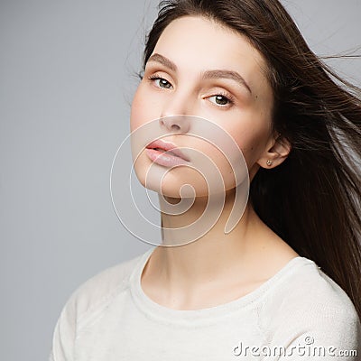 Portrait beautiful young woman with long brown hair. Pretty model poses at studio. Stock Photo