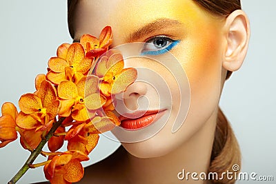Portrait of beautiful young woman with orchid Stock Photo
