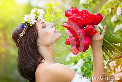 Portrait of a beautiful young woman in a wreath of spring flower Stock Photo