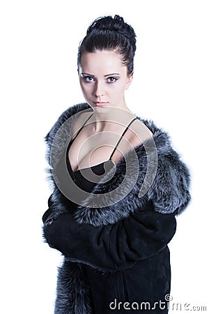 Beautiful brunette with decollete in luxury black color fur coat Stock Photo