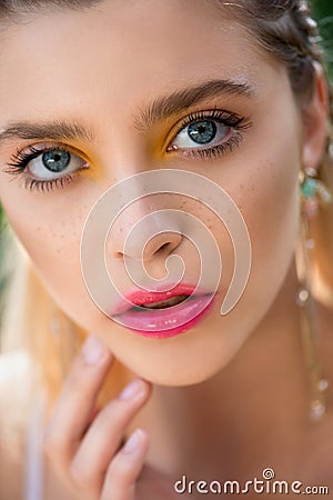 Portrait of beauty model with yellow creative makeup and vivid pink glossy lips, isolated on white. Beautiful young woman with Stock Photo