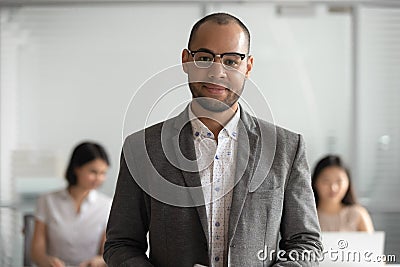 Portrait of biracial male employee in glasses posing at workplace Stock Photo