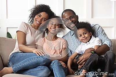 Portrait of black family with kids relax on couch Stock Photo