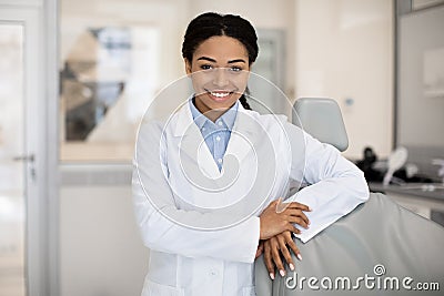 Portrait Of Black Female Dentist In White Coat Posing In Clinic Interior Stock Photo
