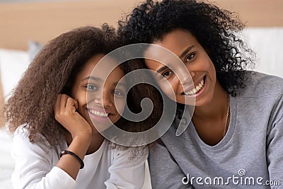 Portrait of black mother and daughter smiling at camera Stock Photo