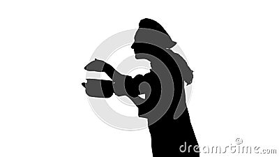 Portrait of black silhouette of a chef female in uniform smelling dish. Stock Photo