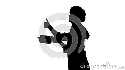 Portrait of black silhouette of a chef female in uniform smelling dish and showing like sign. Stock Photo