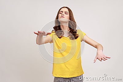 Portrait of blind disoriented brown haired teenager girl in yellow casual T-shirt walking with Stock Photo