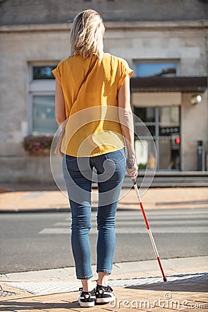 Portrait blind woman crossing road holding stick Stock Photo