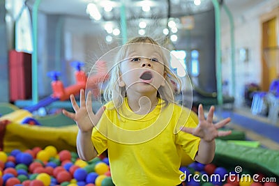 Portrait of a blond boy in a yellow t-shirt. Stock Photo