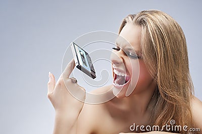 Portrait of Blond Female with Agressive Facial Expression on Audio Cassette Stock Photo