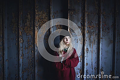 Portrait of blond teenager girl standing indoors in abandoned building. Stock Photo