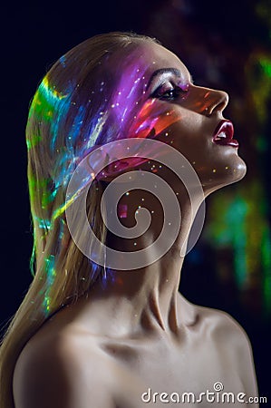 Portrait of blond Woman with shining lights on face Stock Photo