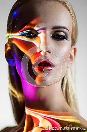 Portrait of blond Woman with shining lights on face Stock Photo