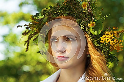 Portrait blond woman with a wreath of flowers on head Stock Photo