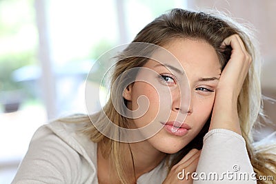 Portrait of blond young woman getting bored Stock Photo