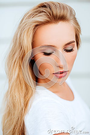 Portrait of blond young woman posing outdoors Stock Photo