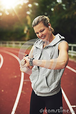 Portrait of blonde athlete looking at her watch Stock Photo