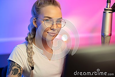 Portrait of Blonde Gamer Girl with Glasses Playing Online Video Game on Her Computer Stock Photo