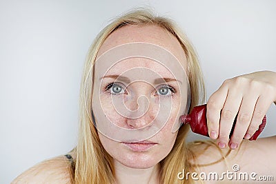 A young woman puts a gel mask on her face. Care for oily, problem skin Stock Photo