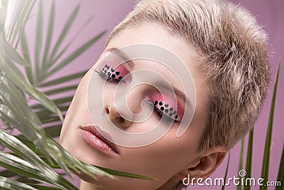 Portrait of blonde girl with artistic makeup. Stock Photo
