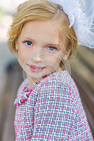 Portrait of a blonde in pink attire in a park outdoors. Stock Photo