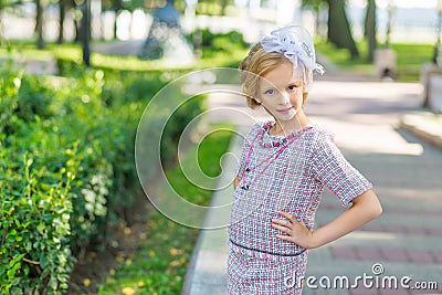 Portrait of a blonde in pink attire in a park outdoors. Stock Photo