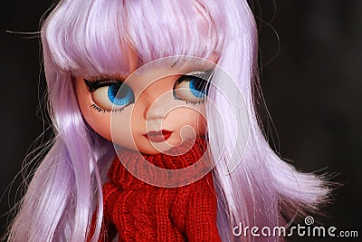 Portrait of Blythe doll with purple hair, blue eyes and red sweater Editorial Stock Photo