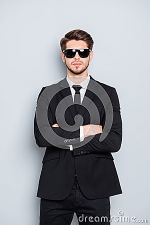 Portrait of bodyguard in black suit and glasses with crossed hands Stock Photo