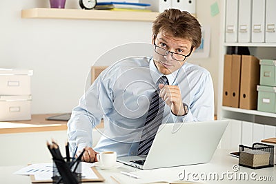 Portrait of bookkeeper or auditor sitting at his workplace Stock Photo