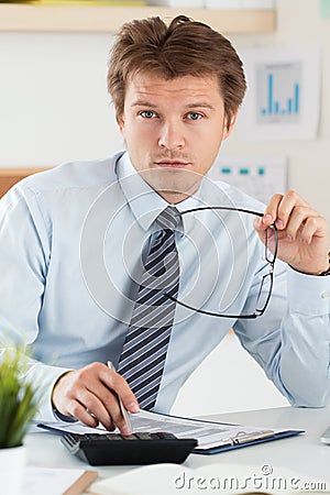 Portrait of bookkeeper or financial inspector holding his glasses Stock Photo