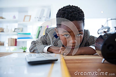 Portrait of bored businessman leaning on desk Stock Photo