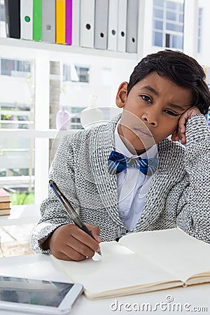 Portrait of bored businessman sitting in office Stock Photo