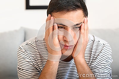 Portrait of bored young man at home Stock Photo