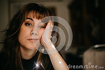 Portrait of bored young woman with led lights Stock Photo