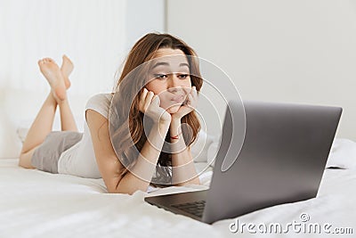 Portrait of a bored young woman lying in bed at home Stock Photo