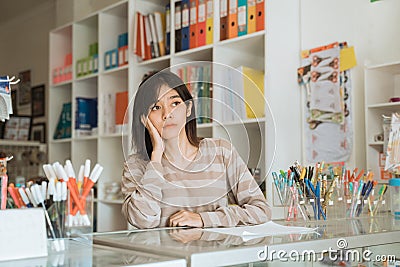 Portrait boring young girl entrepreneur waiting customer Stock Photo