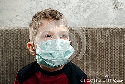 Portrait of a boy, a child in a medical mask. The concept of disease, flu in children, tuberculosis, immunity, protection from Stock Photo