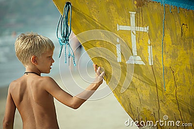 Boy with part of a boat Stock Photo