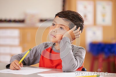 Portrait of a boy daydreaming in an elementary school class Stock Photo