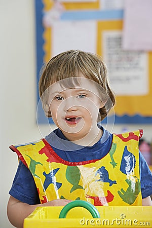 Portrait of boy (5-6) with Down syndrome in kindergarten Stock Photo