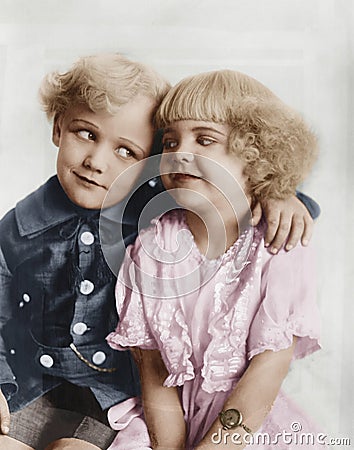 Portrait of a boy and girl with arm around her Stock Photo