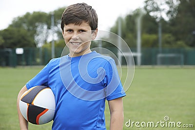 Portrait Of Boy Holding Ball On School Rugby Pitch Stock Photo