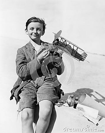 Portrait of a boy holding a model airplane and smiling Stock Photo