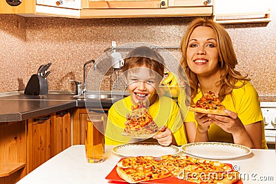 Portrait of boy and mother ready to eat pizza Stock Photo