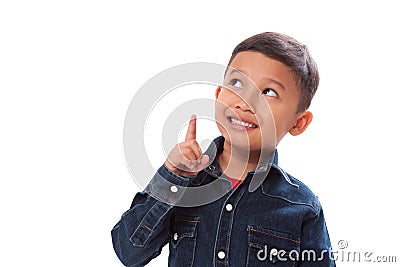 Portrait of boy pointing finger up on white background Stock Photo