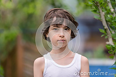 Portrait of a boy in a sleeveless shirt. Stock Photo