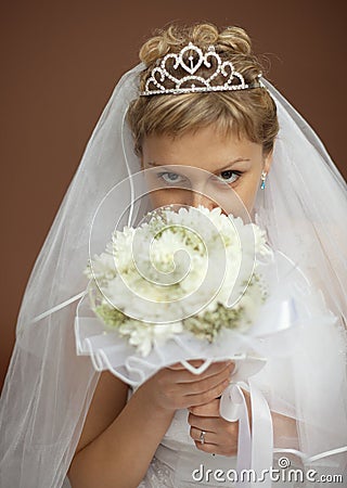 Portrait of bride with bunch of flowers at face Stock Photo