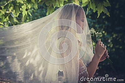 Portrait of bride with veil and bouquet of wild flowers outdoor Stock Photo