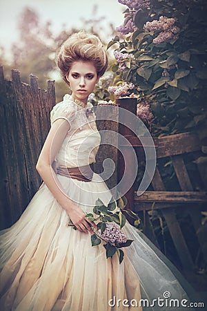 Portrait of a bride in a white dress with flowers in retro style. Stock Photo